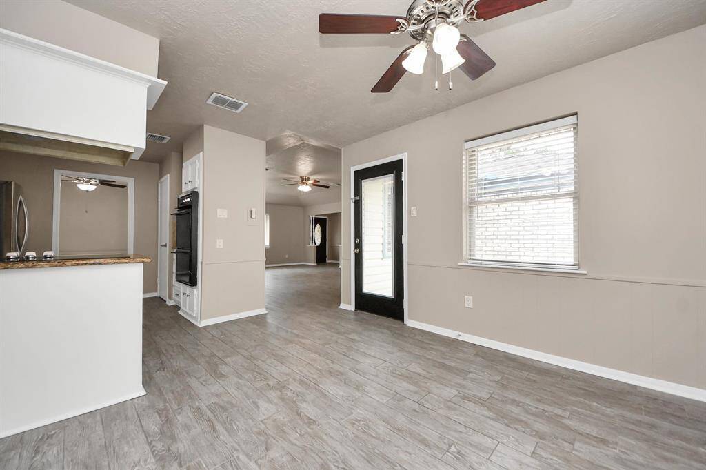 Enjoy an open view from the breakfast area into the kitchen and living room, with easy access to the back patio—perfect for entertaining or everyday convenience.