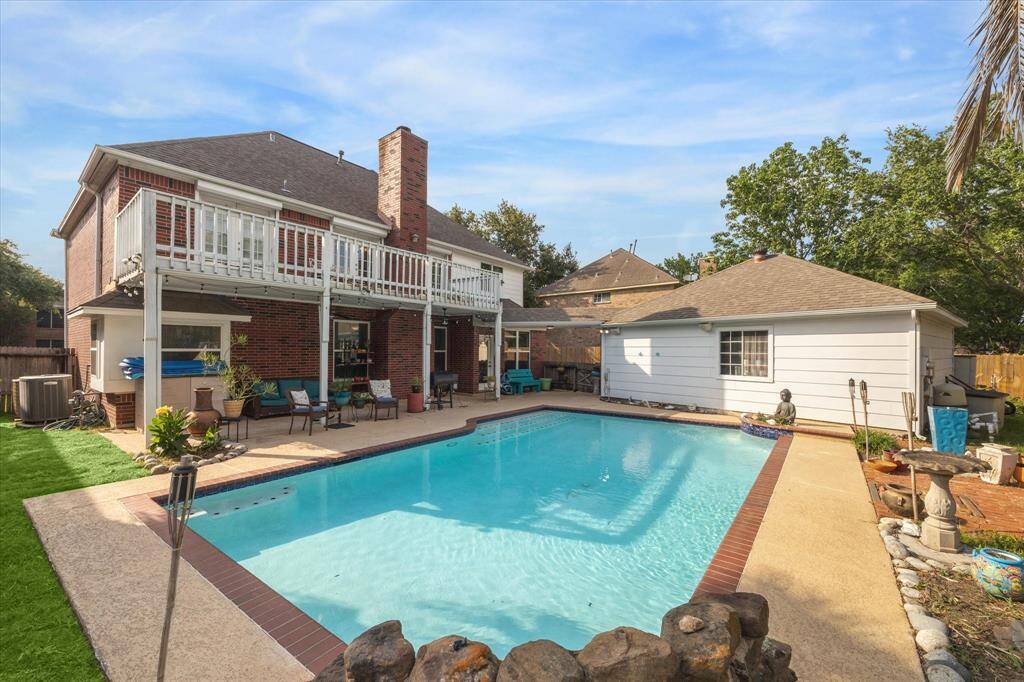 ENJOY THE TROPICAL BACKYARD WITH THE LARGE POOL AND BACK GATE THAT OPENS TO THE PARK COMPLETE WITH BOAT RAMP!