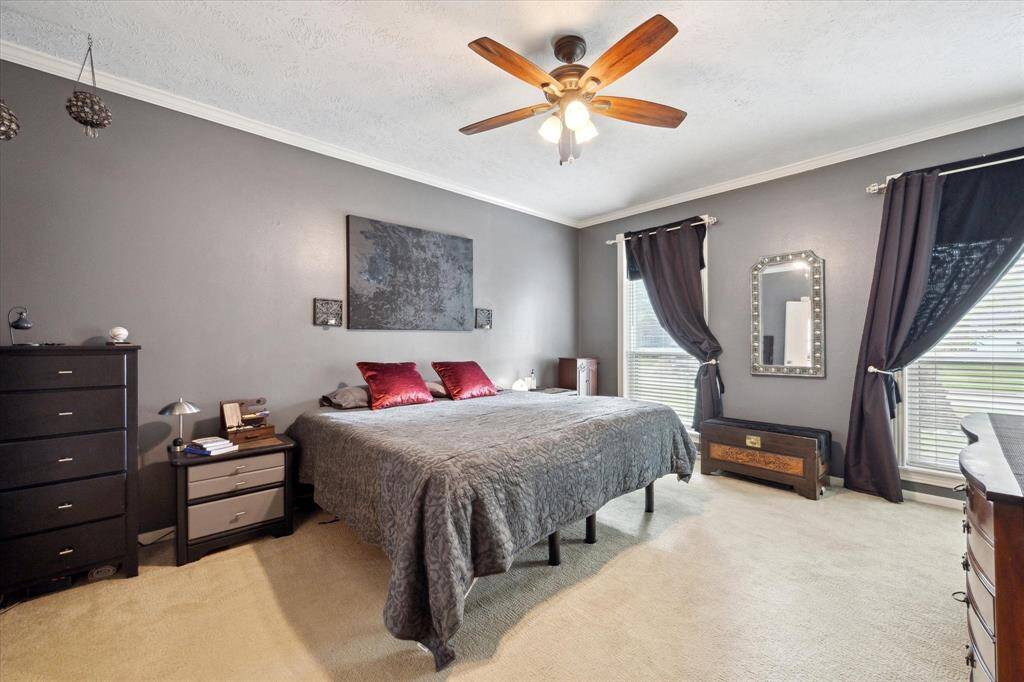 PRIMARY SUITE LOCATED ON THE FIRST FLOOR WITH HIS AND HER CLOSETS.