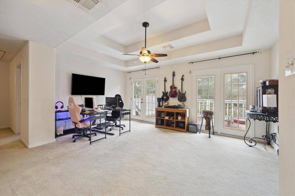 THE GAMEROOM ALSO FEATURES DOUBLE FRENCH DOORS LEADING TO THE BALCONY.