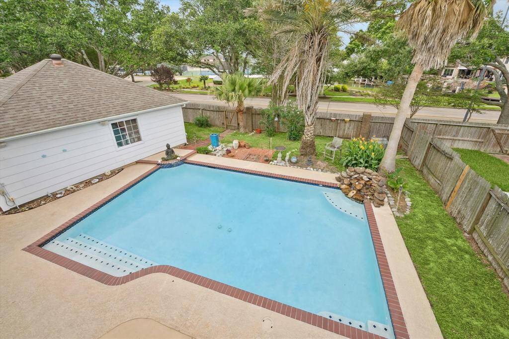 FROM THE BALCONY, YOU CAN ENJOY VIEWS OF THE HUGE POOL AND THE CANAL IN THE BACKGROUND.