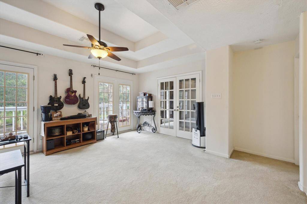 THE GAMEROOM ALSO OPENS TO A HOME OFFICE THROUGH FRENCH DOORS.
