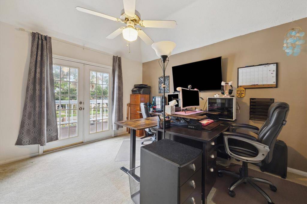 THE OFFICE ALSO OPENS TO THE BALCONY THROUGH FRENCH DOORS.