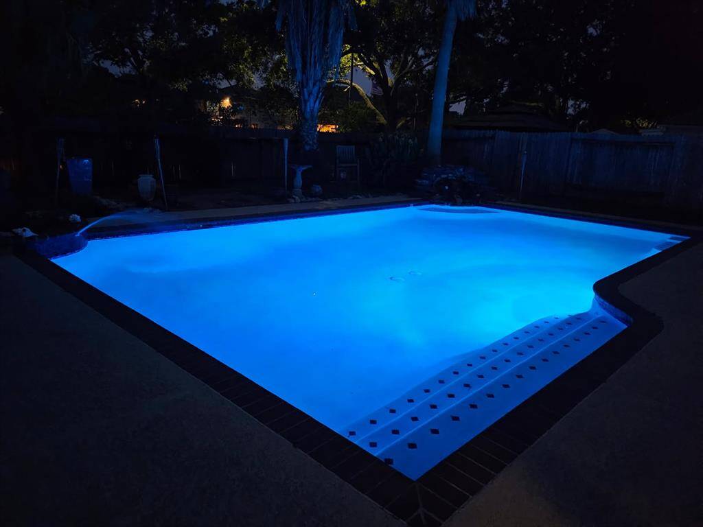 ENJOY THE TROPICAL BACKYARD WITH THE LARGE POOL FEATURING LED LIGHTING.