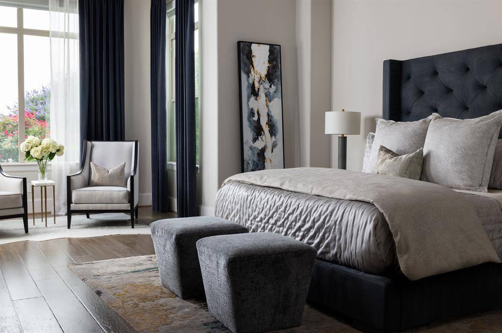 Situated on the main level, the oversized primary suite offers a comfortable seating area and is equipped with blackout shades for ultimate privacy and relaxation.
