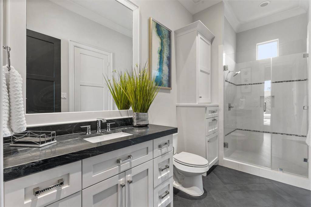 The downstairs guest bathroom is beautifully designed, complete with a full shower, ensuring guests enjoy a touch of luxury.