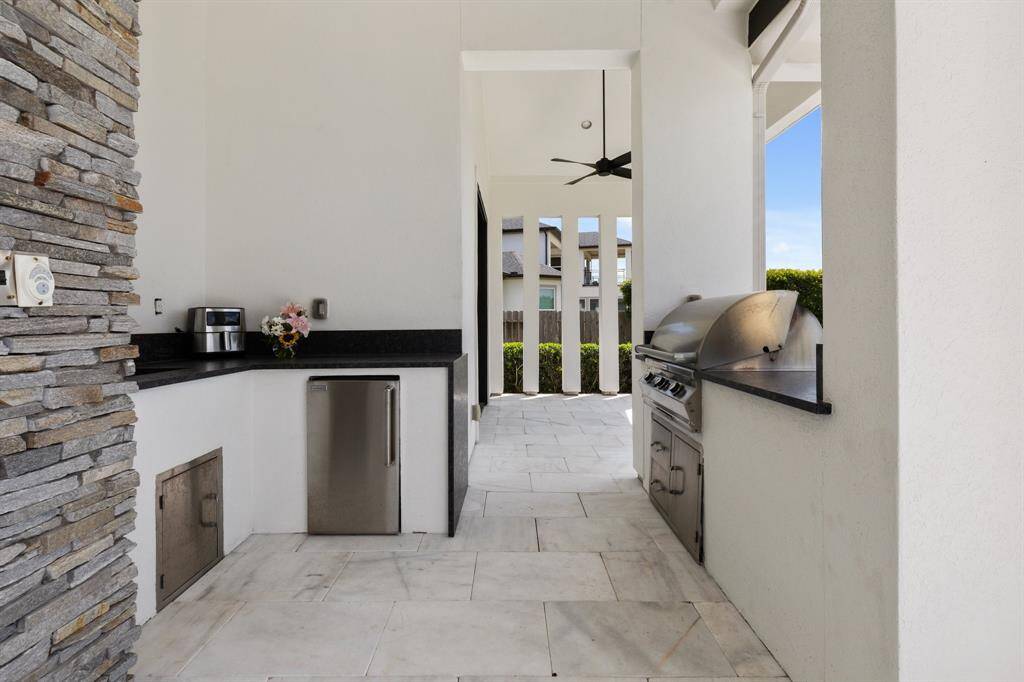 Host unforgettable gatherings in the outdoor kitchen equipped with a grill.