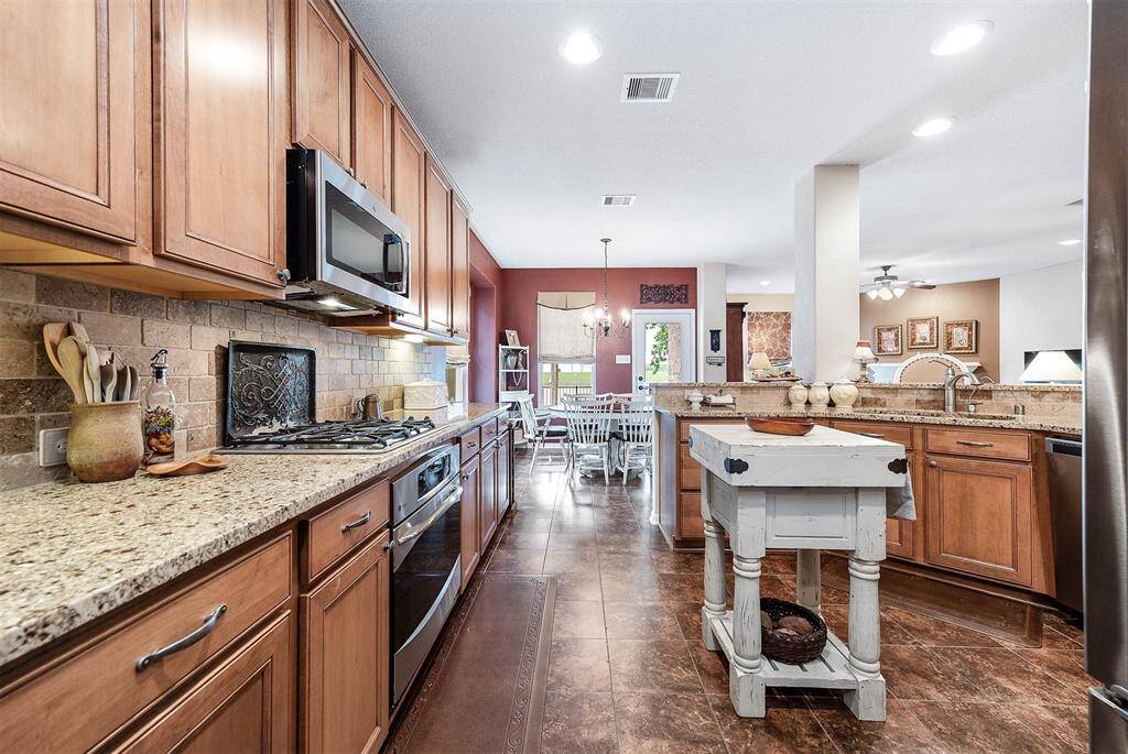 Wow!  The countertops are endless, with rich wood-grain cabinets and drawers offering ample storage space.