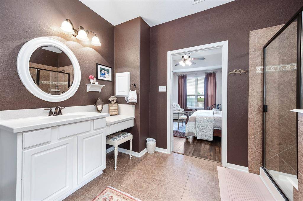 From this angle of the room you will note the vanity area, accent lighting and tile floors