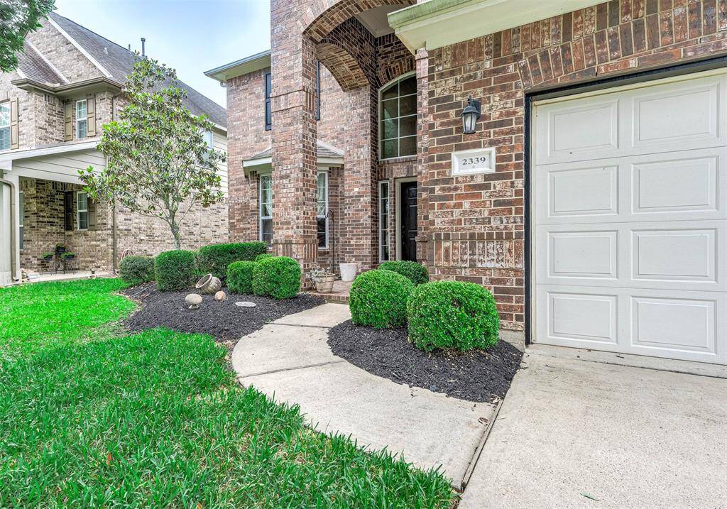 Double-wide driveway leads to the covered entrance