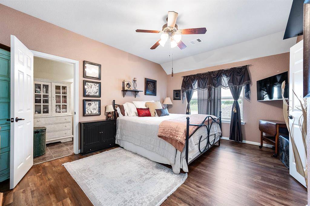 Considered the upstairs "primary bedroom", this room spans the next three pictures!  Its got the bed area, sitting / dressing area, and its own bath.