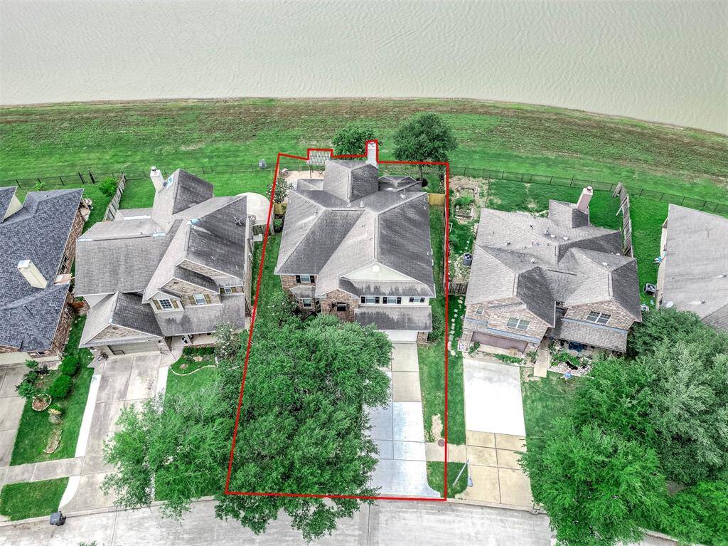 An aerial shot shows the placement of the home on the Lakefront lot, giving the home and back yard a sense of privacy due to it being nestled just a bit further back on the lot.