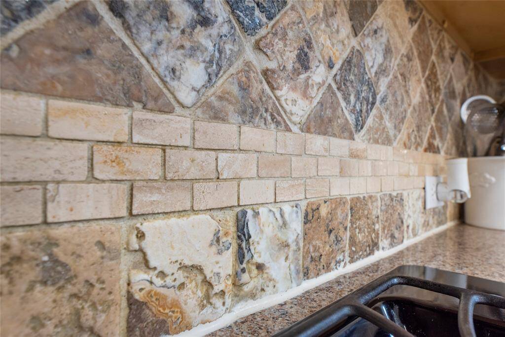 Designer tiled backsplash adds to the atmosphere.