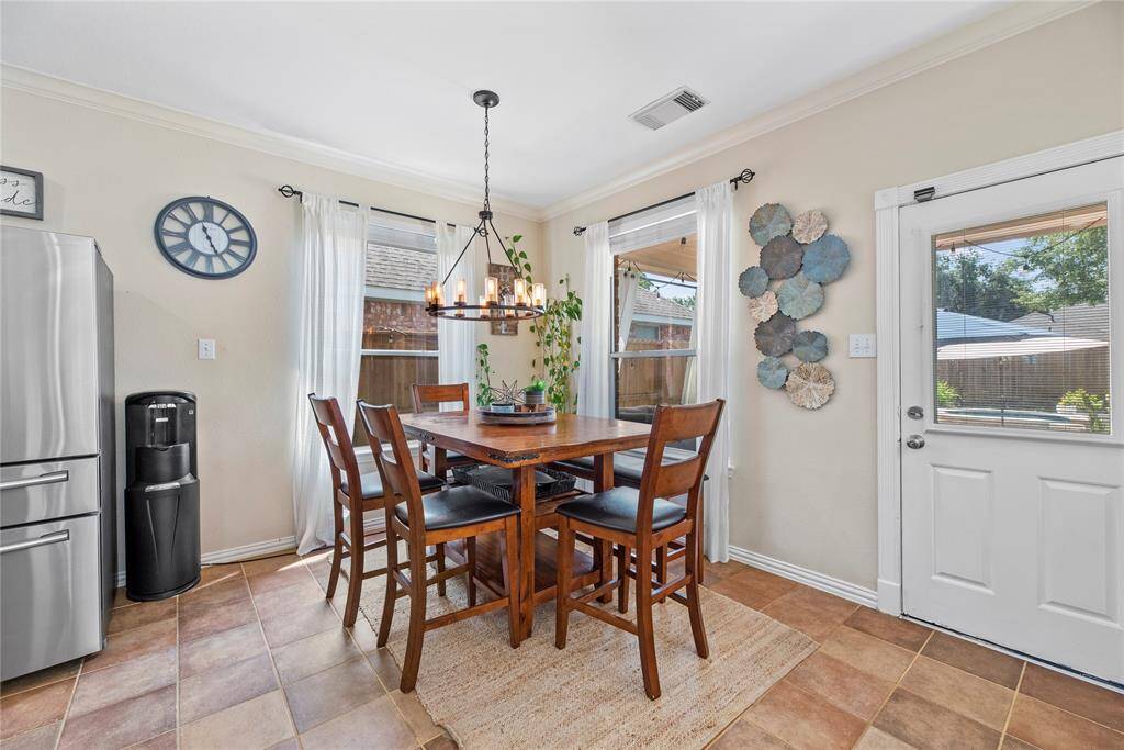 Enjoy sunlit mornings in the inviting breakfast area, ideally positioned near the back door for easy indoor-outdoor living.