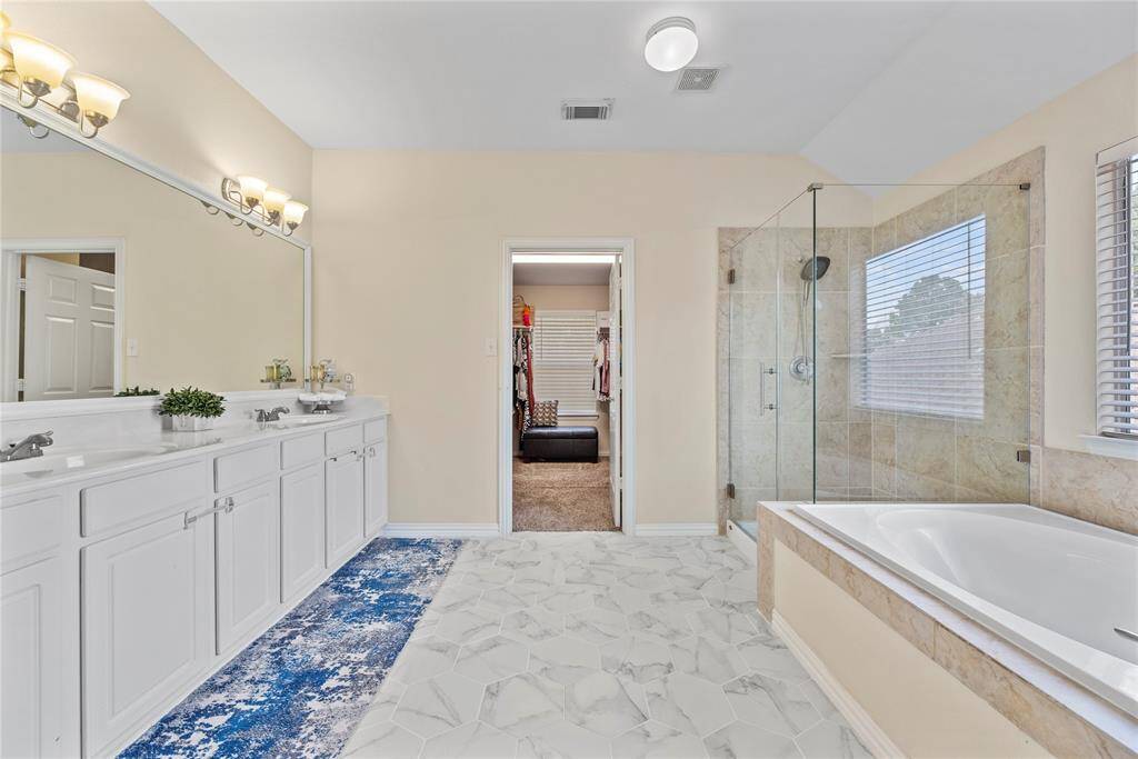 Dual vanities in your primary bath, offer personal space with tons of dedicated cabinet space.