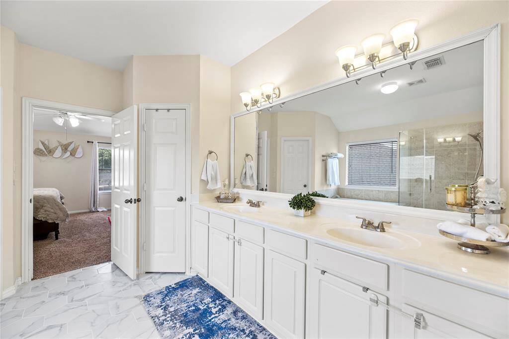 The primary bathroom is private and inviting, roomy enough to move around comfortably.