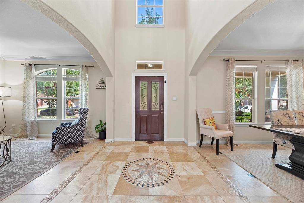 A warm welcome awaits in the foyer, featuring beautiful tile flooring that blends style and function.