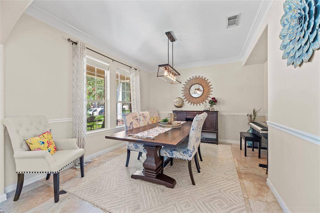 The dining room offers a cozy setting for gatherings, with seamless access to the kitchen for easy entertaining.