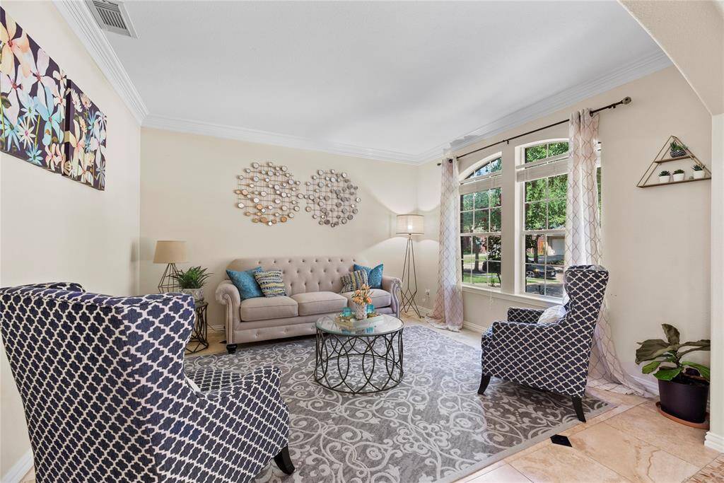 Whether used as a formal living room or a quiet sitting area, this flexible space adapts beautifully to your needs.