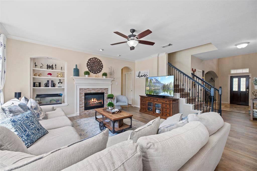 The living room centers around a charming fireplace, creating a cozy focal point for relaxing or entertaining.