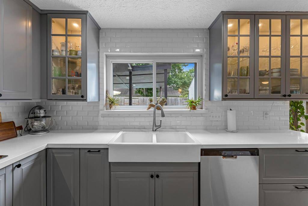 Some cabinets in the kitchen features glass fronts & lighting inside them.