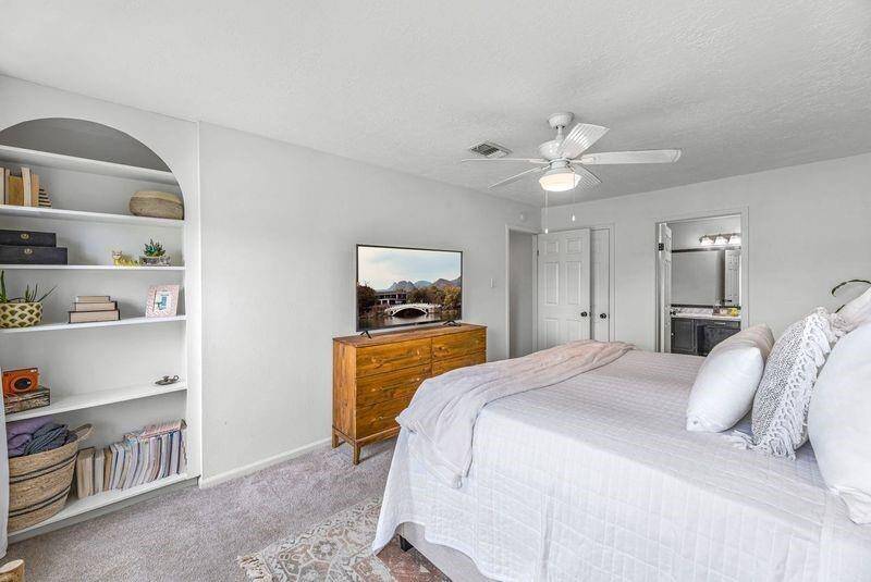 Retire for the evening in this amazing Primary Bedroom that features this built in arch shelf to displace your collectables.
