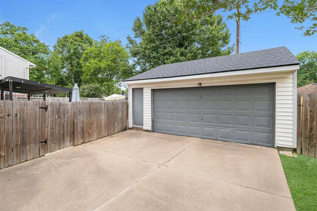 Detached 2 car garage with a door for easy access.