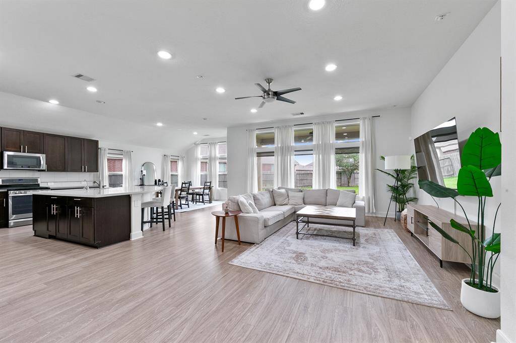 Large picture windows throughout the living room and breakfast room allow ample natural light to warmly illuminate the home.
