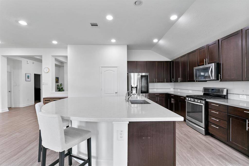 Add a few barstools and the island becomes a breakfast bar- the perfect spot for a quick bite to eat.