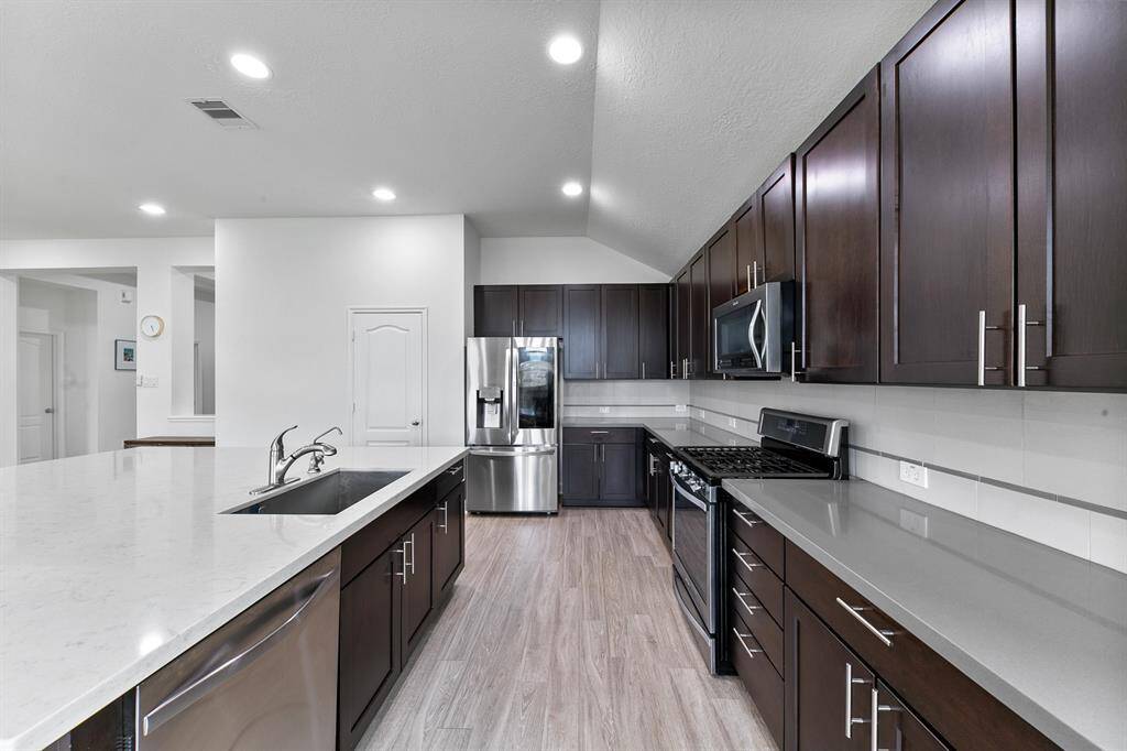 Tons of counter space wrapped around this spacious kitchen. With so many cabinets and drawers, it'll be easy to keep those counters clutter-free!