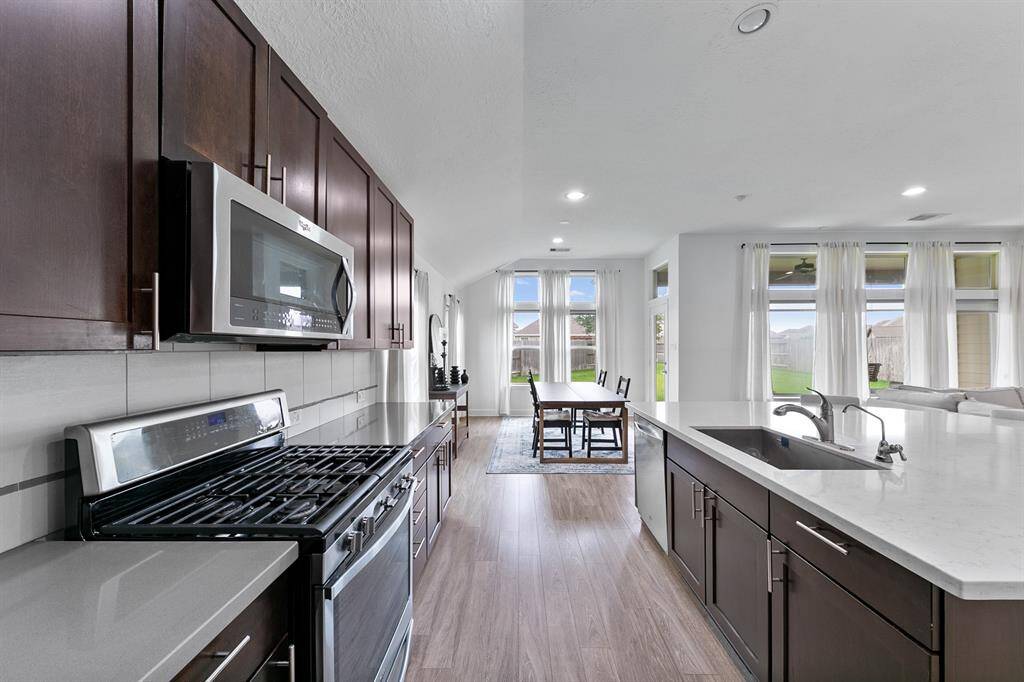 Natural light glistens on the floors, countertops, and stainless steel appliances. You'll love preparing your meals in this light and airy space.