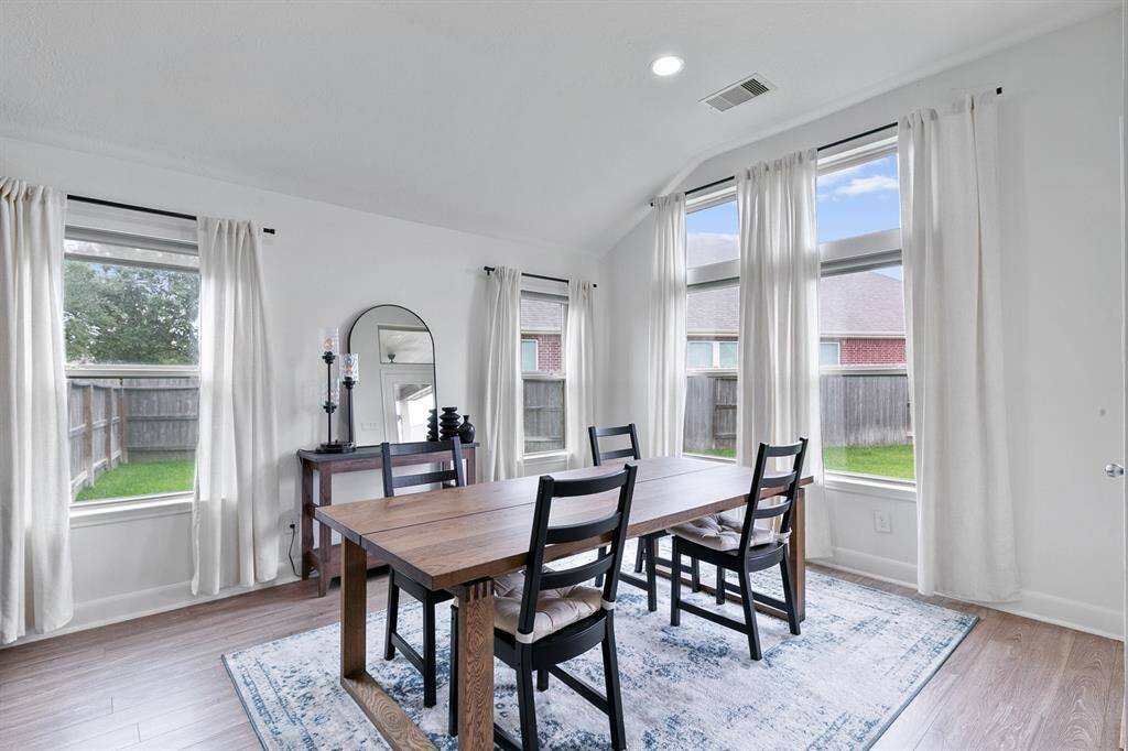 A spacious breakfast area or casual dining spot is wrapped in window views.