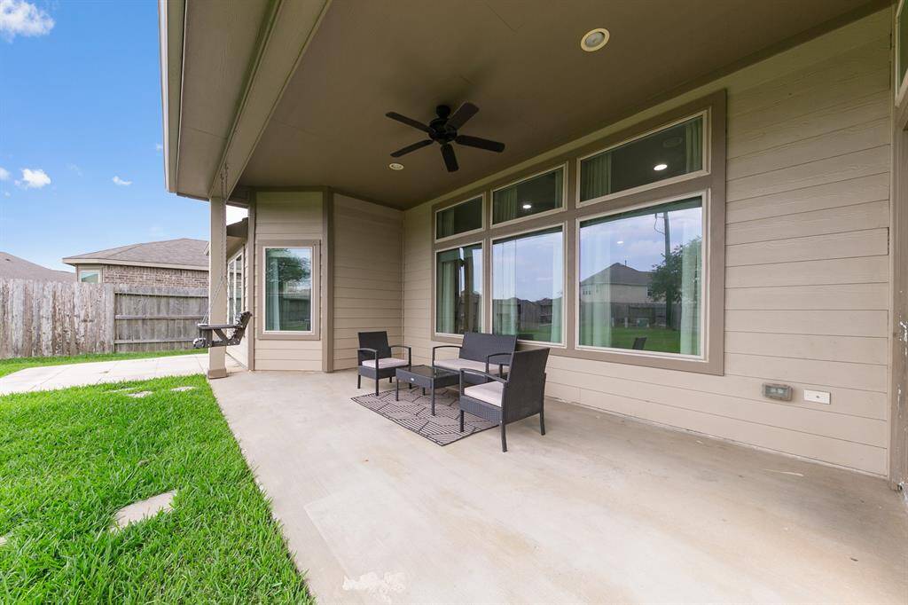 Who doesn't love a covered patio in the backyard!? There's plenty of room here for a table and chairs, not to mention a grill.