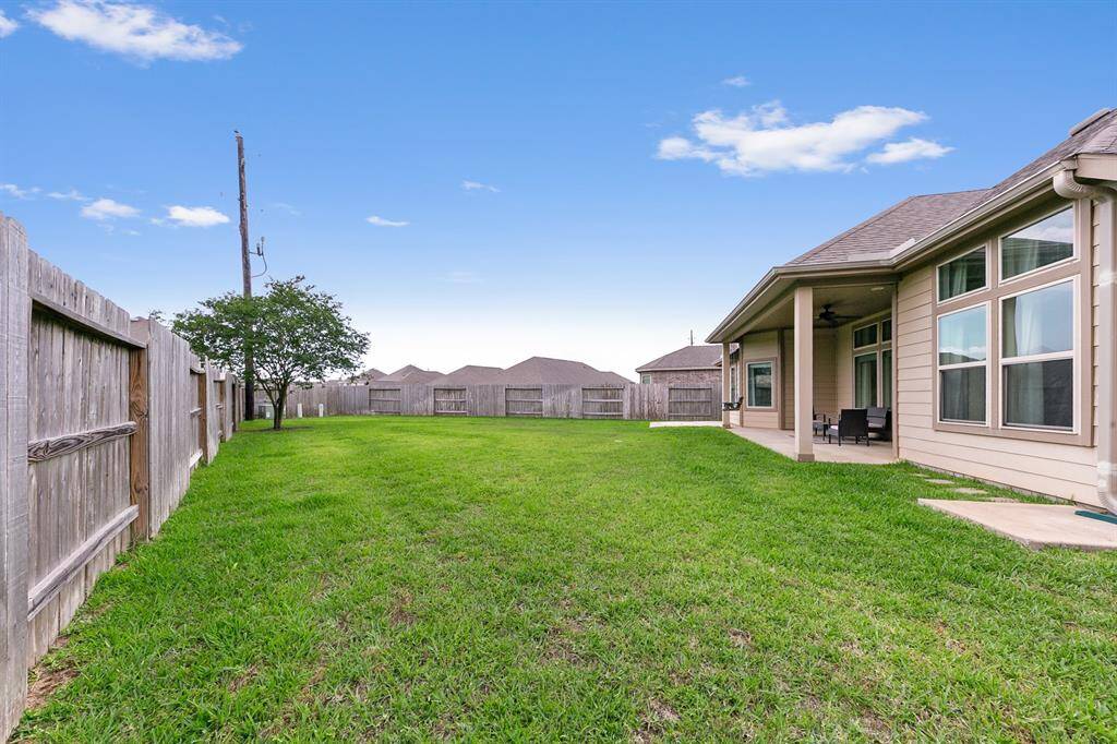 The patio overlooks a massive backyard, definitely large enough to add outdoor raised gardens or even a pool!