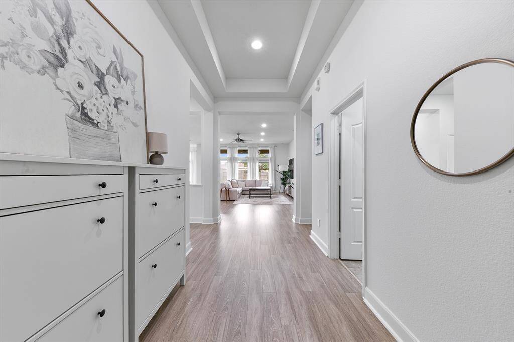 Step inside the formal entry and note the light and airy vibe right away! Beautiful engineered wood floors connect all areas of the open floor plan seamlessly.