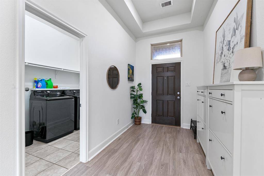 To the right of the entry a large utility room has plenty of space to double as a mud room.