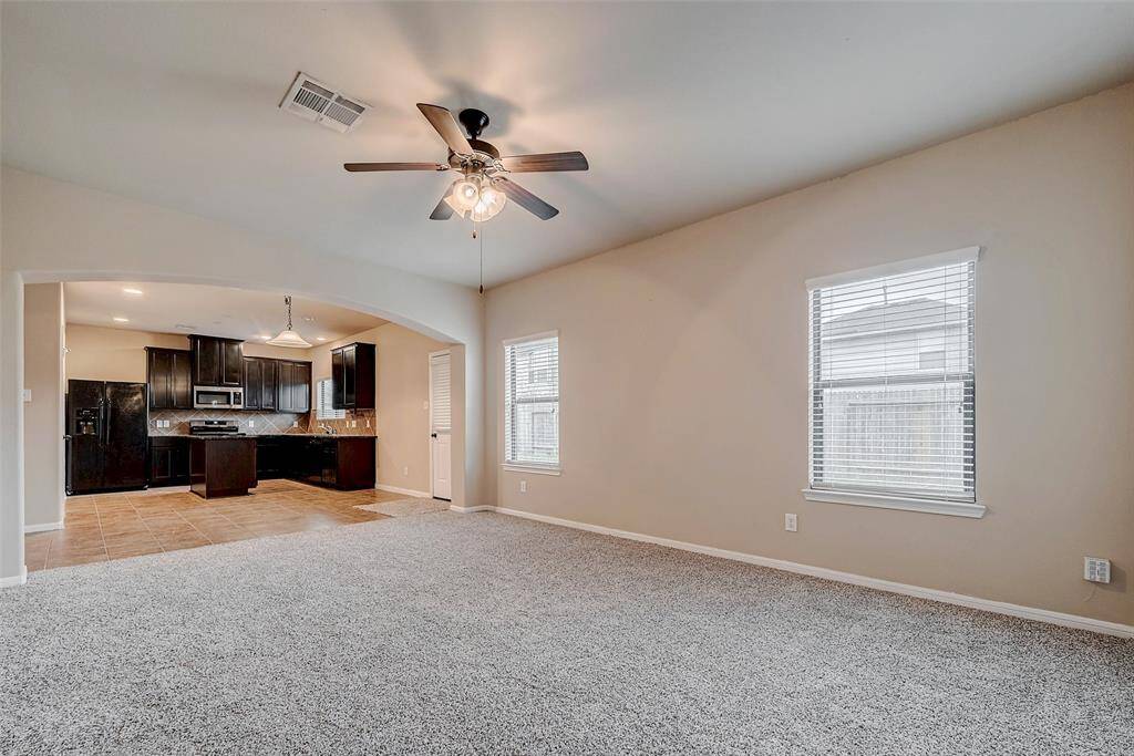 Open concept kitchen leading to living room.