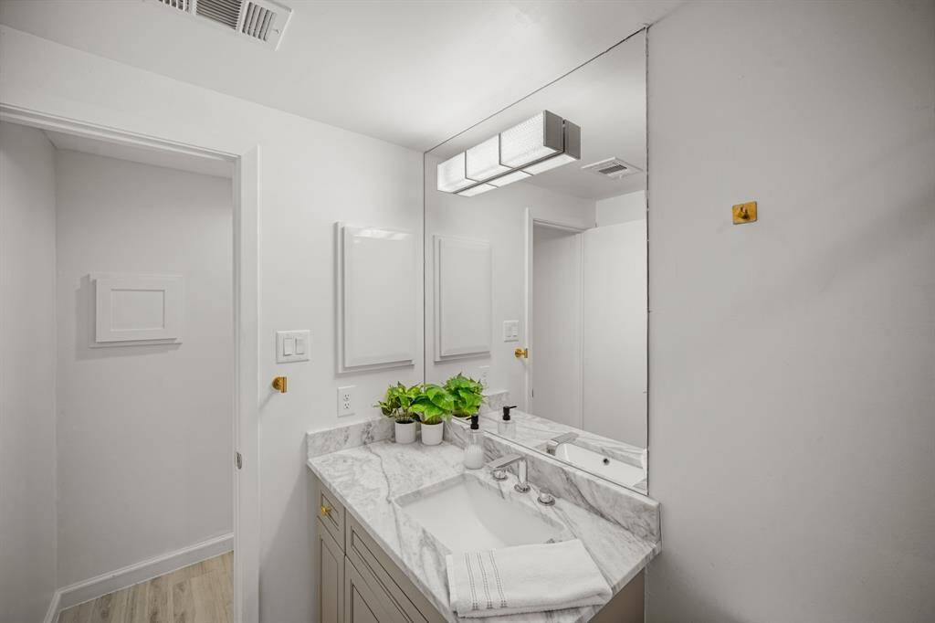 Quartz countertop with updated lighting and hardware