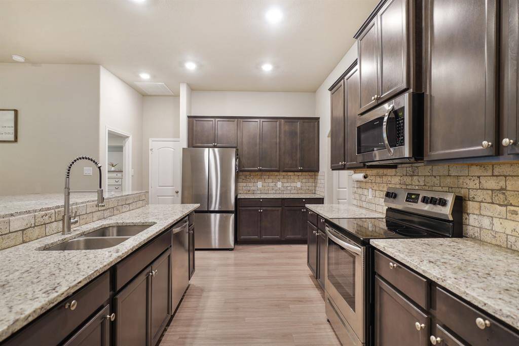 This fully equipped kitchen has great illumination, plenty of counterspace and cabinetry, and stainless steel appliances.