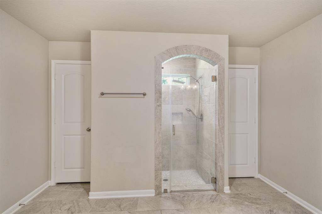 Stunning walk-in shower with tile walls.
