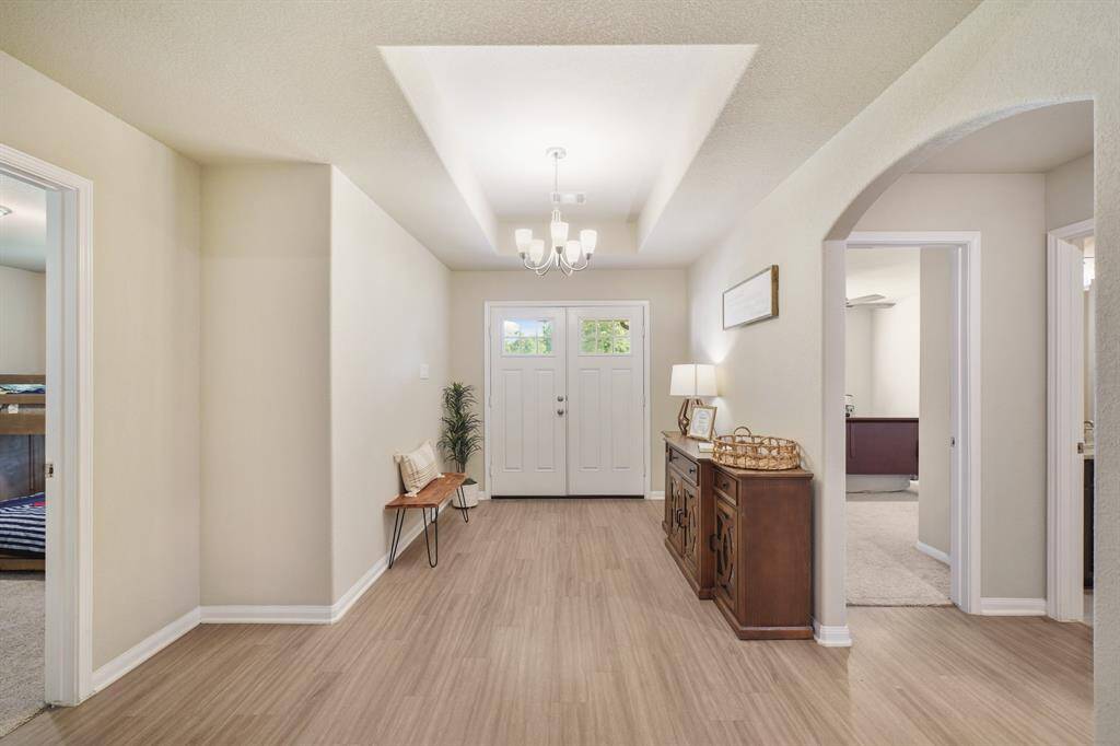 The foyer has a fantastic tray ceiling with pendant lighting.
