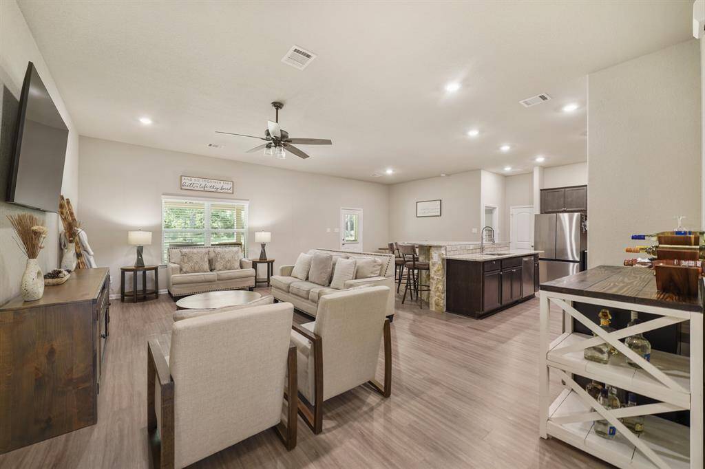 Walk past the foyer, and be mesmerized by this fantastic open layout seamlessly connecting the living, kitchen and dining areas.