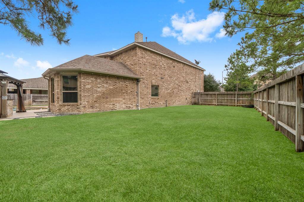 Spacious side yard for play set or garden.