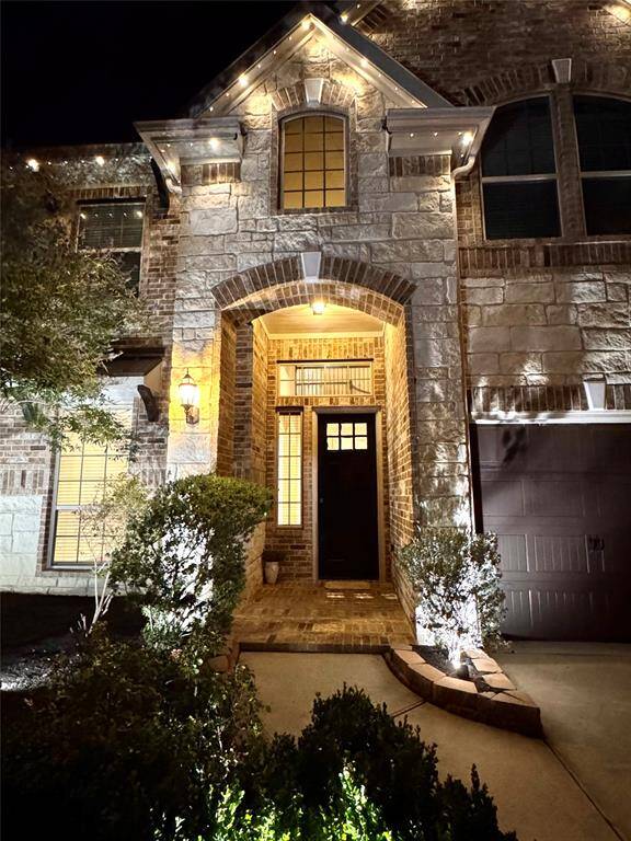Front of house at night with permanent accent lighting