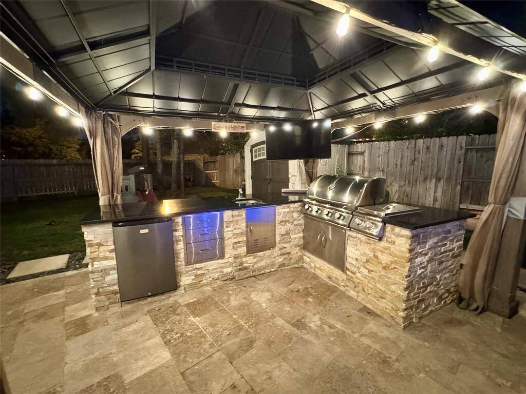 Outdoor kitchen at night with lights