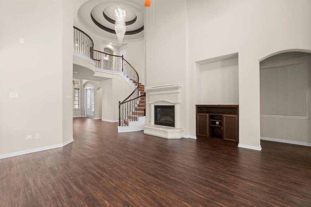Family room and staircase with gorgeous chandelier