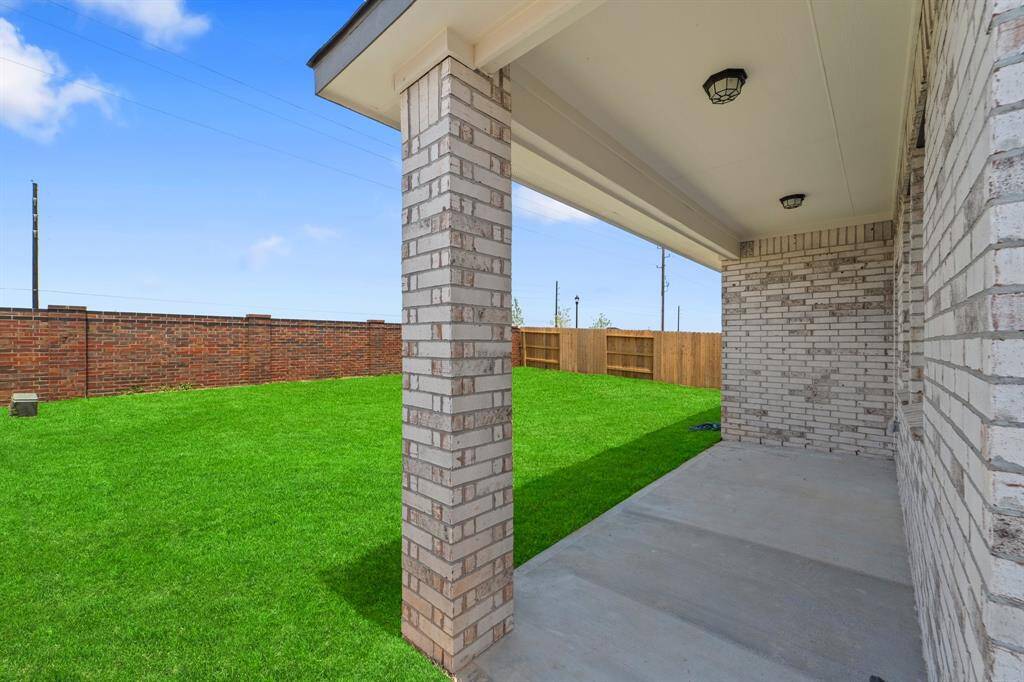 The covered patio is generously sized, providing ample space for various outdoor activities.
