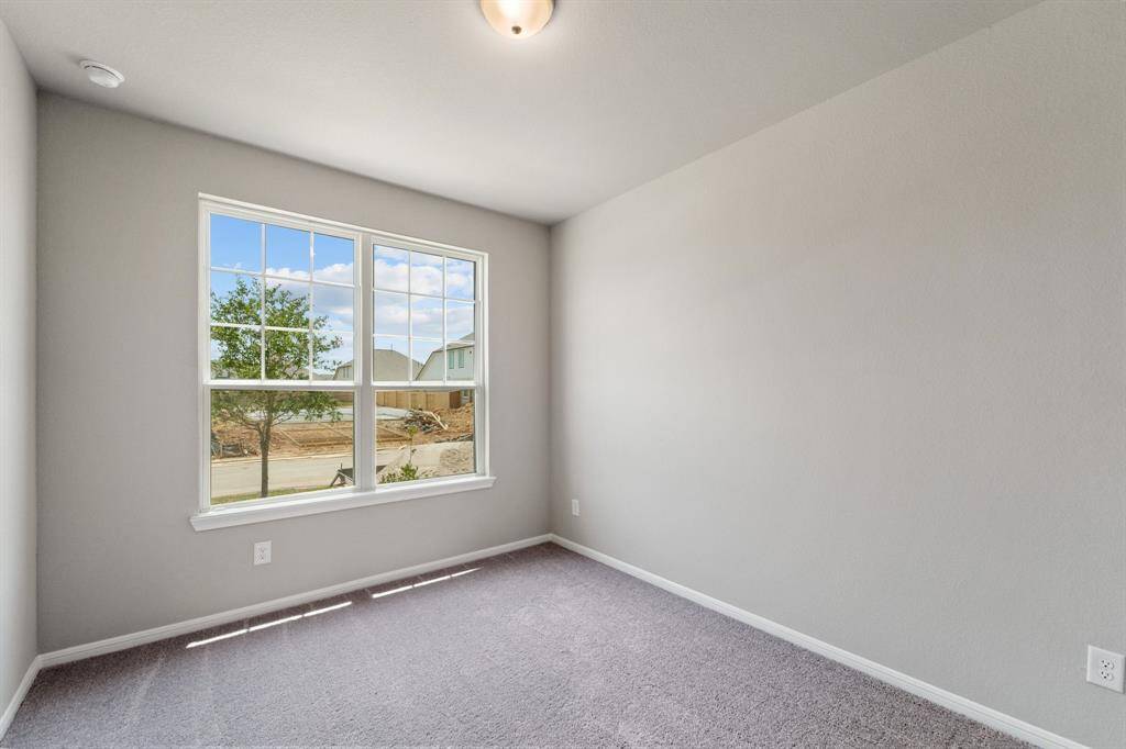 Your secondary bedroom features plush carpet, fresh paint, closet, and a large window that lets in plenty of natural lighting.