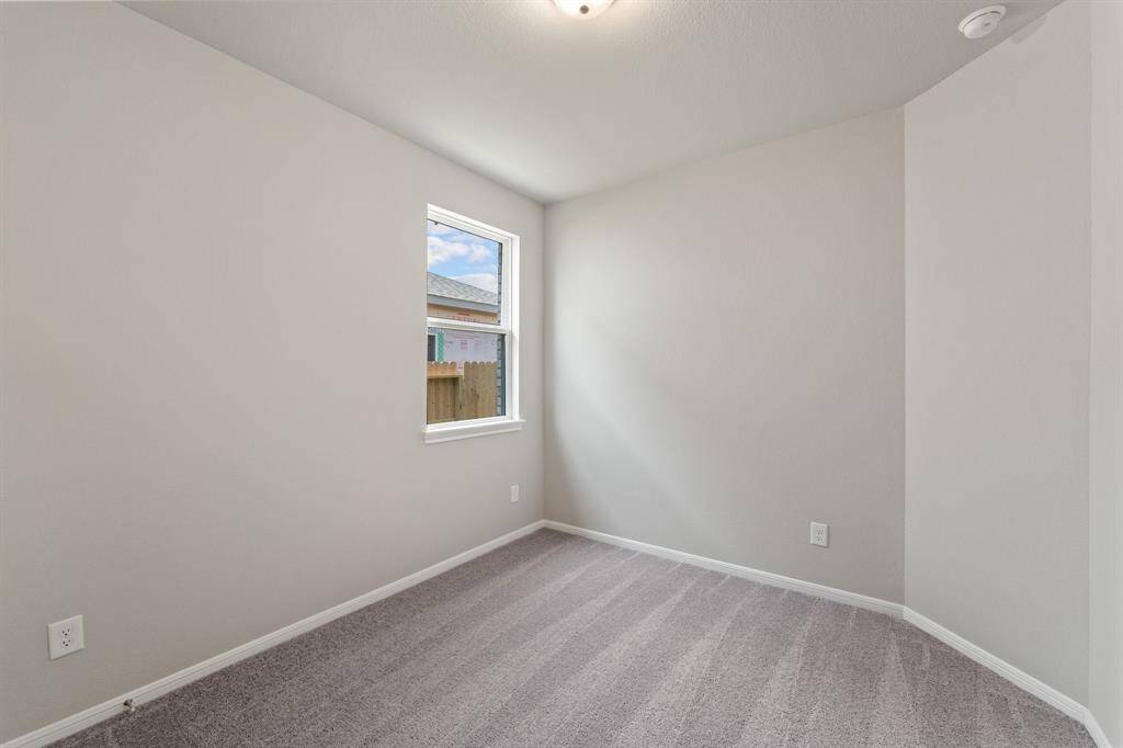 Your secondary bedroom features plush carpet, fresh paint, closet, and a large window that lets in plenty of natural lighting.