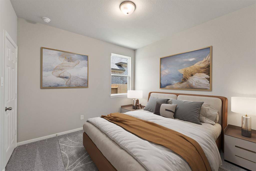 Your secondary bedroom features plush carpet, fresh paint, closet, and a large window that lets in plenty of natural lighting.